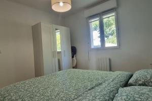 a white bedroom with a bed and a window at Maison Bohême" entre Collègues ou Famille - Piscine Jacuzzi jusqu'à fin septembre in Saint-Seurin-sur-lʼIsle