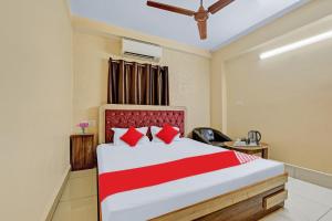 a bedroom with a large bed with red pillows at Flagship Sri Jagarnath Banquet & Hotel in Rānchī