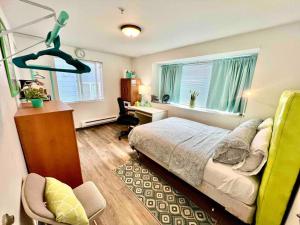 a bedroom with a bed and a desk and a window at Micro Studio Apartment in University District- 10 Minutes walk to UW in Seattle