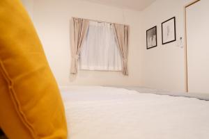 a bed in a room with a window at Liaison Court Universal Gateway in Osaka