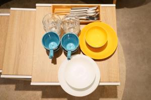 a wooden table with plates and bowls and glasses at Liaison Court Universal Gateway in Osaka +49 photos