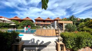 a resort with a swimming pool and a resort at PS Thana Resort in Choeng Mon Beach