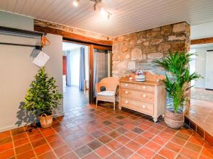 a room with a stone wall and a dresser and plants at Beautiful g te in Jalhay 5 minutes from the Hautes Fagnes in Tiège