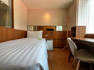 Postel nebo postele na pokoji v ubytování 盤古捷旅 - Panco Hotel
