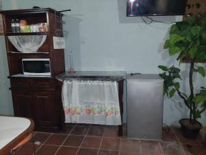 a living room with a table and a microwave at Nirvana 2, Habitación doble con todos sus servicios in Guatemala