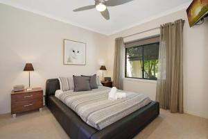 a bedroom with a large bed and a window at Brookside in Bright