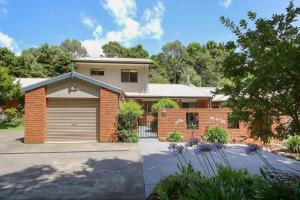 a brick house with a garage at Brookside in Bright
