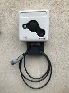a video game controller hooked up to a charger at Budget by Hotel Savoy Hannover in Hannover