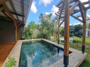 a swimming pool in the backyard of a house at Tropical 3-bedrooms Coastal Residence Creolia in Grand Baie