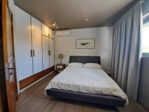 a bedroom with a large bed and a window at Tropical 3-bedrooms Coastal Residence Creolia in Grand Baie