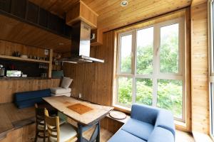 a kitchen and dining room with a table and chairs at Niseko Nikuyadoya in Niseko
