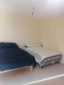 - une chambre avec 2 lits et un mur blanc dans l'établissement Puerto Mar 201, à Acapulco