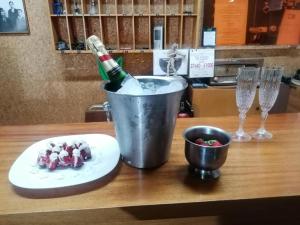 a bottle of champagne in a bucket on a table at HOTEL ALEXANDROS in Loutraki