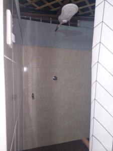 a shower in a bathroom with a tile wall at Nirvana 2, Habitación doble con todos sus servicios in Guatemala
