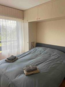 a bedroom with a bed with two towels on it at Clair Vue A3 near Télécabine by Jolidi in Nendaz