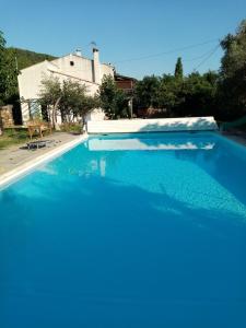 a large blue swimming pool in front of a house at Maison d'hôtes éco-responsable avec piscine 6X12m LIRE L'ANNONCE VOTRE HÔTE SVP in Châteaudouble