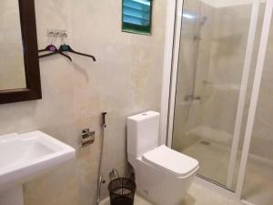 a bathroom with a toilet and a shower and a sink at Villa Sanitha in Ambalangoda