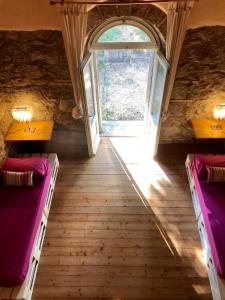 an attic room with two beds and a window at Collina Blu in Bolsena
