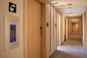 a corridor of corridors in a hospital with a blue door at Hotel Alexander in Krakow