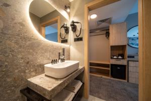 a bathroom with a sink and a mirror at Hotel Alexander in Krakow