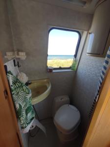 a small bathroom with a sink and a toilet at Keros Summer Camp in Kalliópi