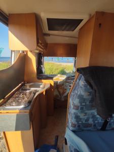 an interior view of an rv with a stove at Keros Summer Camp in Kalliópi