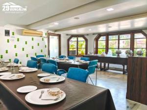 a dining room with a table and a piano at Hilltop suites by 29 bungalow in Khandāla