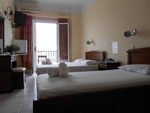 Ένα ή περισσότερα κρεβάτια σε δωμάτιο στο Ξενοδοχείο Λητώ