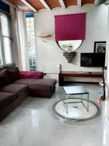 a living room with a couch and a table at zentral club neutron-jacuzzi in Belmonte de Miranda +27 photos