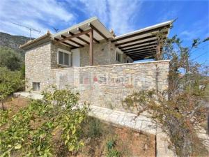 a stone house in the middle of a field at Villa Katafyki (2 independent houses) in Ermioni