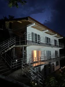 a building with a balcony and stairs at night at Orsova Gratca 164 in Orşova