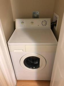 a washer and dryer in a small room at Modern Private Suite Close to Everything in Vancouver