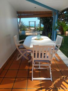 a white table and chairs on a patio at La perle rare - Réunion in La Saline les Bains