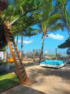 a bunk bed and a ladder in front of a beach at La perle rare - Réunion in La Saline les Bains +20 photos