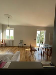 a living room with a couch and a table at Langhetta's house - Alta Langa in Murazzano