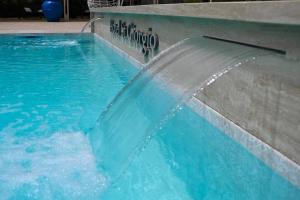 a pool with a water fountain in a swimming pool at Hotel St. Giorgio in Castel San Giorgio
