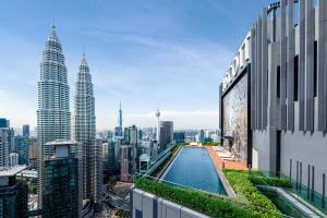 a view of a city from a building with a pool at Ascott Star KLCC in Kuala Lumpur