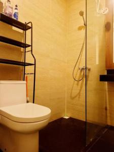 a bathroom with a toilet and a shower at Vimalla Hills Villa Resort Exclusive Villa Puncak in Gadok 1