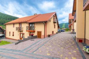 a building with a red roof on a street at Spark in Bukovel