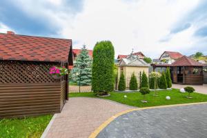 a house with a driveway and a yard with trees at Spark in Bukovel