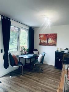 a room with a table and chairs and a window at Xantener Ferienhaus Heeser Weg in Xanten