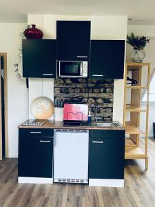 a kitchen with blue cabinets and a counter top at Xantener Ferienhaus Heeser Weg in Xanten