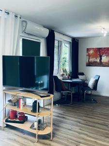 a living room with a large flat screen tv at Xantener Ferienhaus Heeser Weg in Xanten