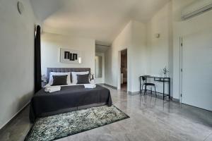 a bedroom with a large bed and a table at Villa Martin Noel in Poreč