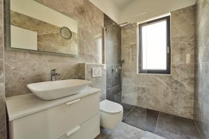 a bathroom with a sink and a toilet at Villa Martin Noel in Poreč