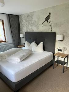 a bedroom with a bed with a bird on the headboard at Ferienhaus Waldner in Kaunertal