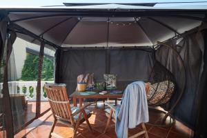 a gazebo with a table and chairs under it at Apartment San Pietro in Cavtat