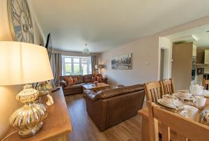 a living room with a couch and a table at Styche View, beautiful 4 bedroom home available in Market Drayton