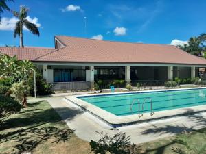 a house with a swimming pool in front of it at Bayswater subdivision guest house .. in Agus