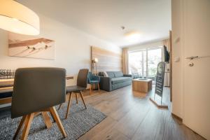 a living room with a table and a couch at Apartments Gustav by Schladming-Appartements in Schladming